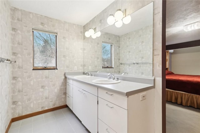 bathroom featuring a wealth of natural light, tile patterned flooring, and vanity