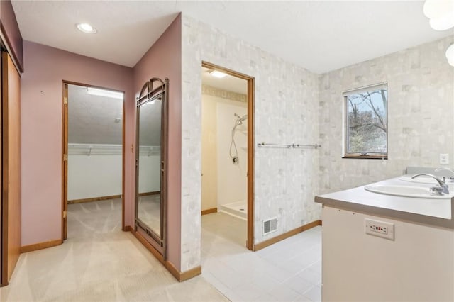 bathroom with vanity and a shower