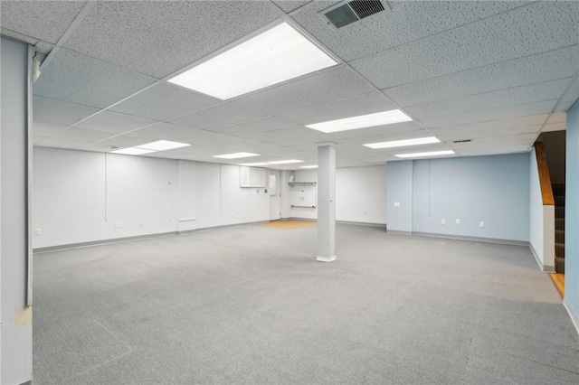 basement featuring carpet flooring and a paneled ceiling