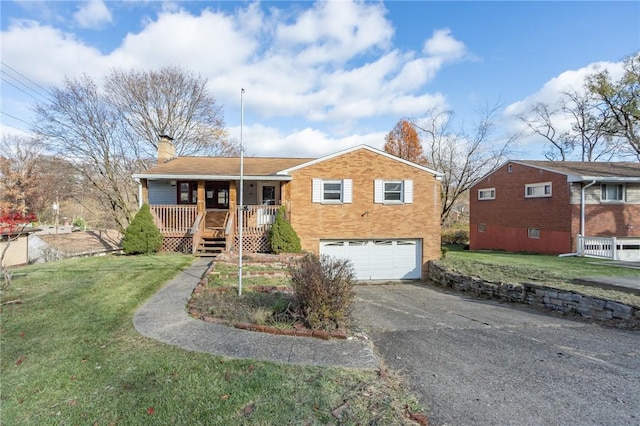 view of front of home featuring covered porch, a front yard, and a garage