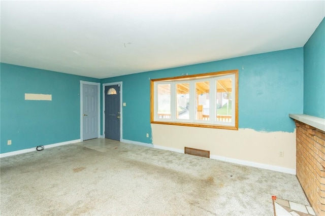 unfurnished living room with a fireplace and light colored carpet