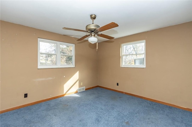 empty room featuring carpet floors and ceiling fan