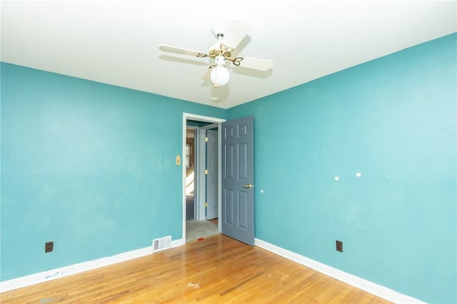 empty room with wood-type flooring and ceiling fan