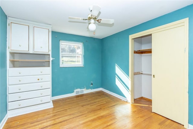 unfurnished bedroom with ceiling fan, a closet, and light hardwood / wood-style flooring