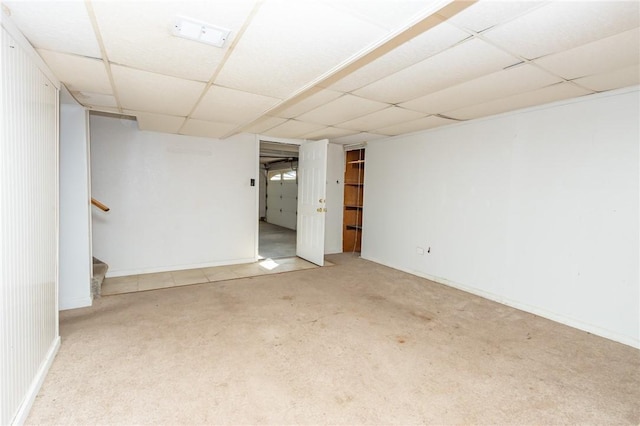 carpeted spare room featuring a paneled ceiling