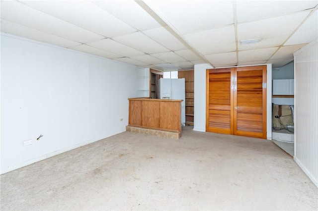 unfurnished living room with a drop ceiling