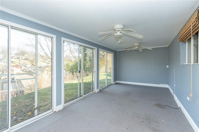 unfurnished sunroom featuring ceiling fan