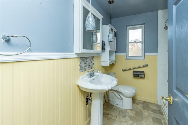 bathroom featuring tasteful backsplash and toilet