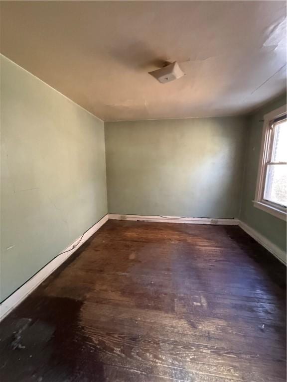 empty room featuring dark wood-type flooring