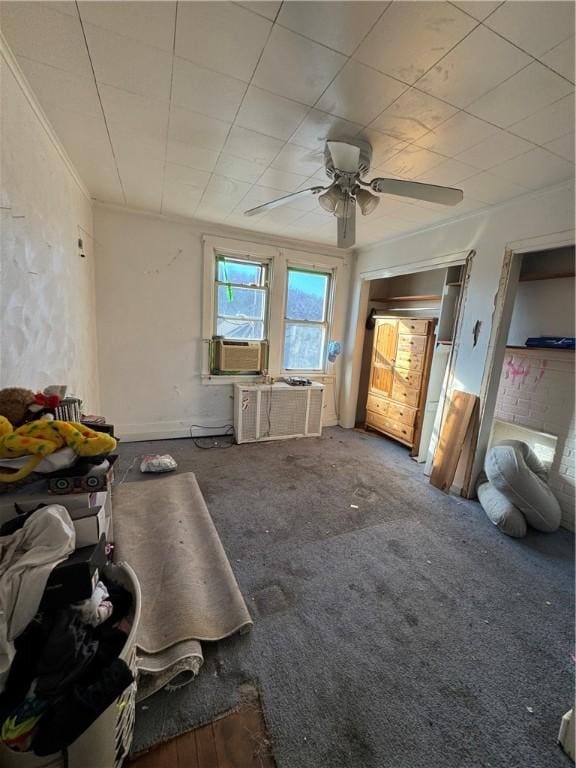 miscellaneous room featuring carpet flooring, ceiling fan, crown molding, and cooling unit