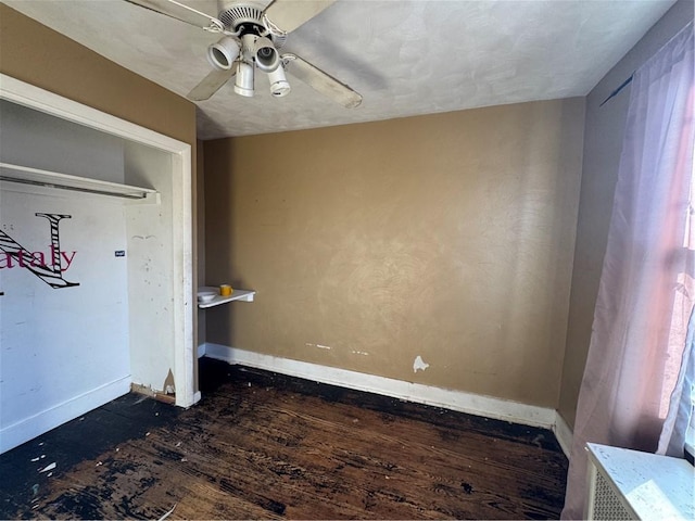 interior space with ceiling fan and dark hardwood / wood-style floors