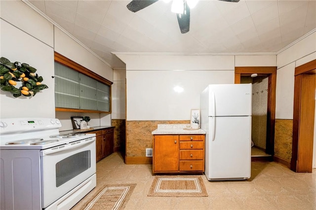 kitchen featuring white appliances, ceiling fan, and crown molding