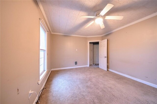 unfurnished room featuring carpet flooring, ornamental molding, and ceiling fan