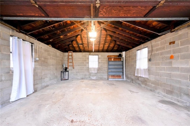 misc room featuring concrete flooring, vaulted ceiling, and wood ceiling