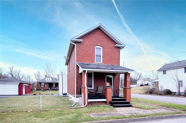 front facade with a porch and a front lawn