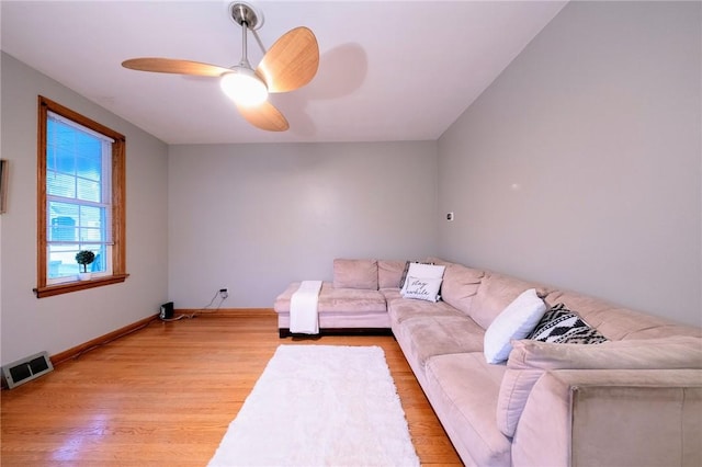 living room with light wood-type flooring and ceiling fan