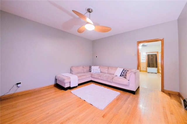 unfurnished living room featuring ceiling fan and light wood-type flooring