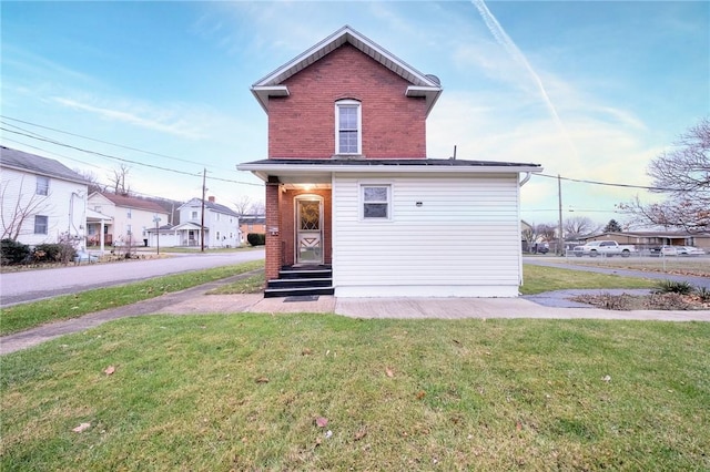 rear view of property featuring a yard