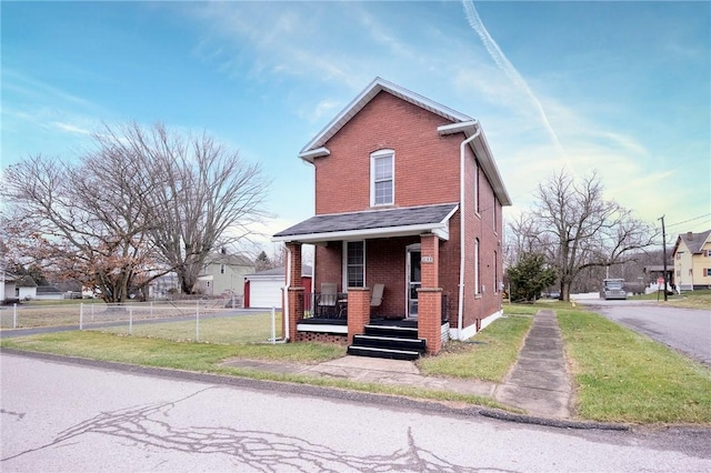 view of front of home featuring a front yard, a garage, and covered porch