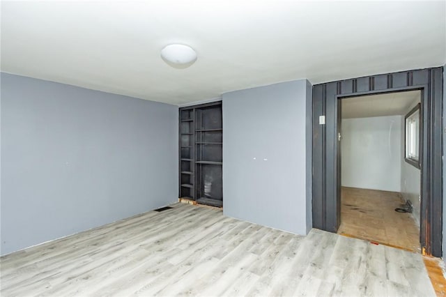 unfurnished room with light hardwood / wood-style flooring