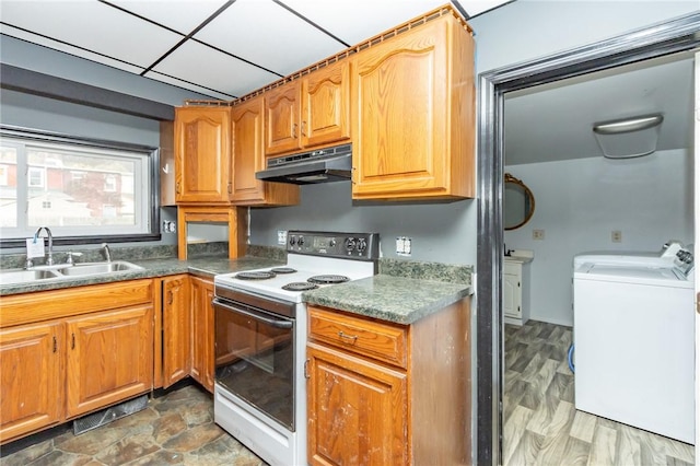 kitchen featuring white range with electric stovetop, washer and clothes dryer, and sink