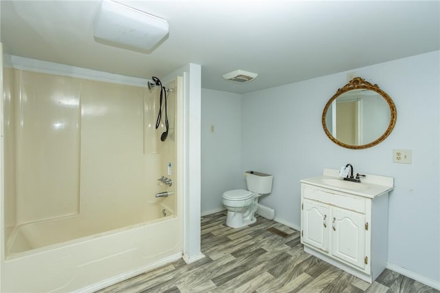 full bathroom featuring vanity, hardwood / wood-style flooring, toilet, and shower / washtub combination