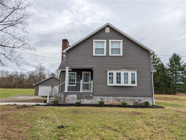 view of front of property featuring covered porch, a garage, an outdoor structure, and a front yard