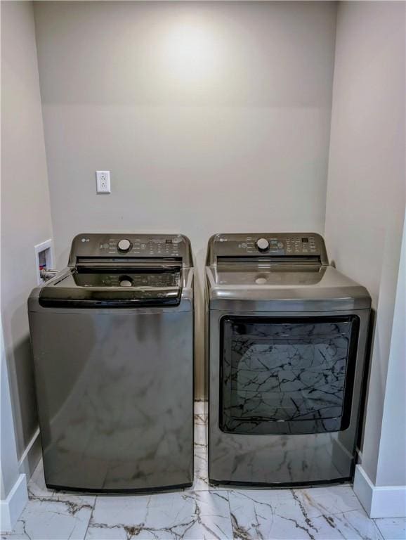 laundry room featuring separate washer and dryer