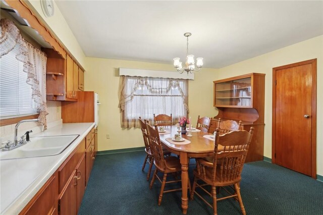 carpeted dining area with a notable chandelier and sink