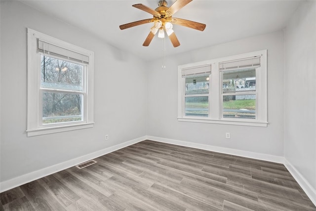 empty room with hardwood / wood-style flooring and ceiling fan