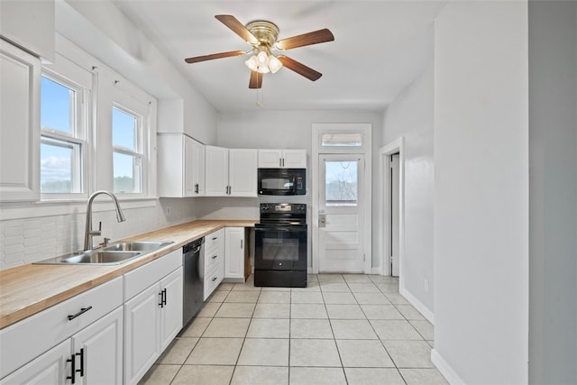 kitchen featuring white cabinetry, sink, a wealth of natural light, and black appliances