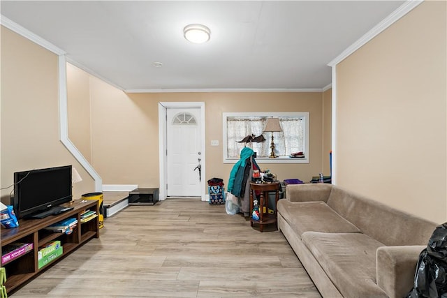 living room with ornamental molding and light hardwood / wood-style flooring