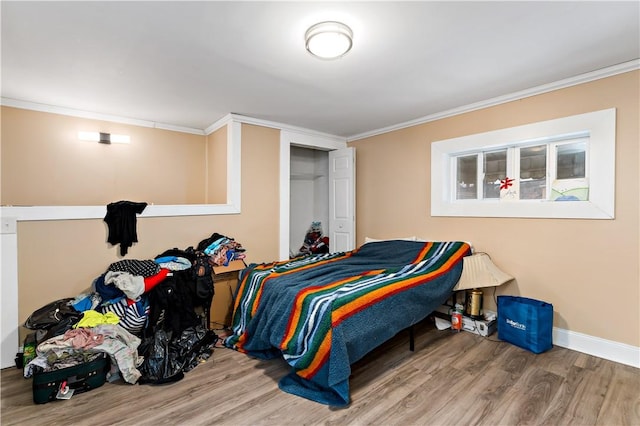 bedroom featuring hardwood / wood-style floors and ornamental molding