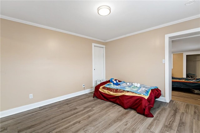 bedroom featuring hardwood / wood-style floors and ornamental molding