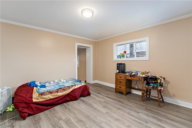 bedroom featuring light hardwood / wood-style flooring and ornamental molding