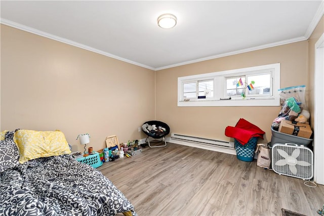 bedroom with ornamental molding, hardwood / wood-style flooring, and a baseboard heating unit