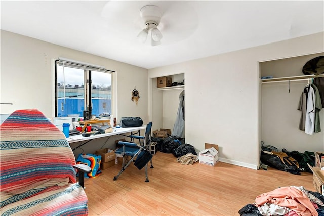 bedroom with ceiling fan, a closet, and wood-type flooring