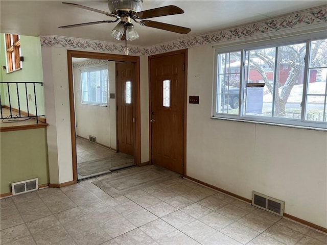 foyer featuring ceiling fan and a healthy amount of sunlight