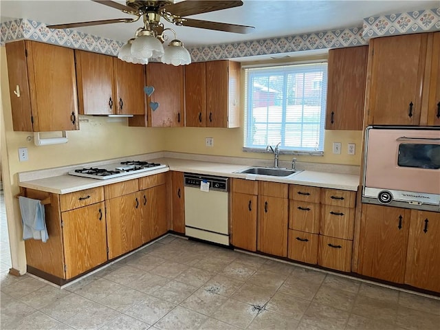 kitchen featuring ceiling fan, white appliances, and sink