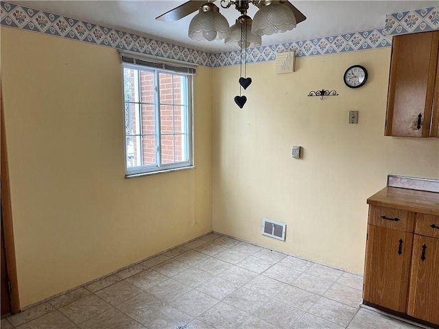 unfurnished dining area with ceiling fan