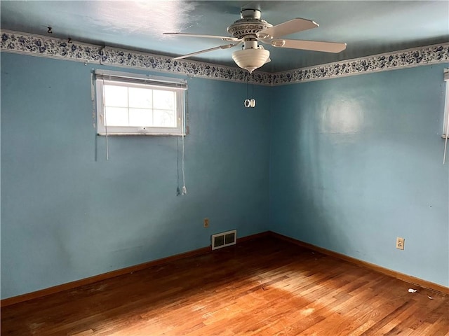 unfurnished room with hardwood / wood-style flooring and ceiling fan