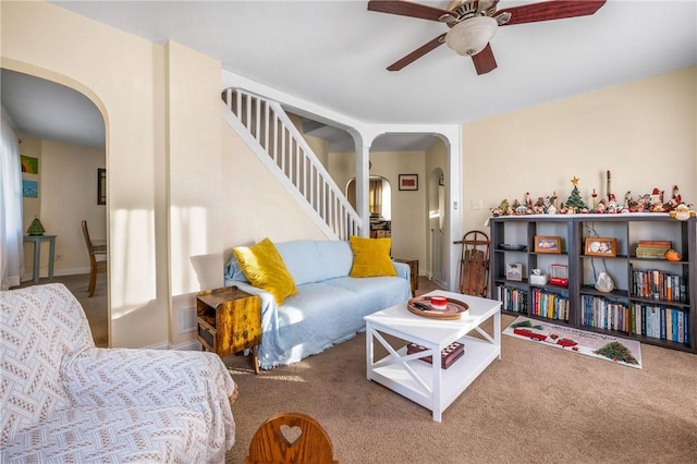 living room featuring carpet flooring and ceiling fan