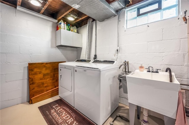 clothes washing area featuring cabinets, separate washer and dryer, and sink