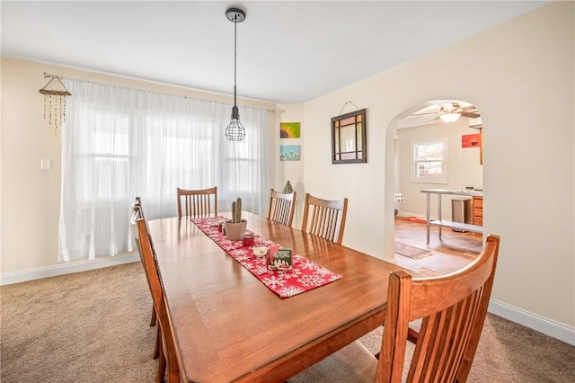 carpeted dining area featuring ceiling fan