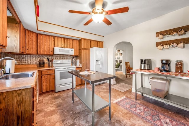 kitchen with decorative backsplash, sink, ceiling fan, and white appliances