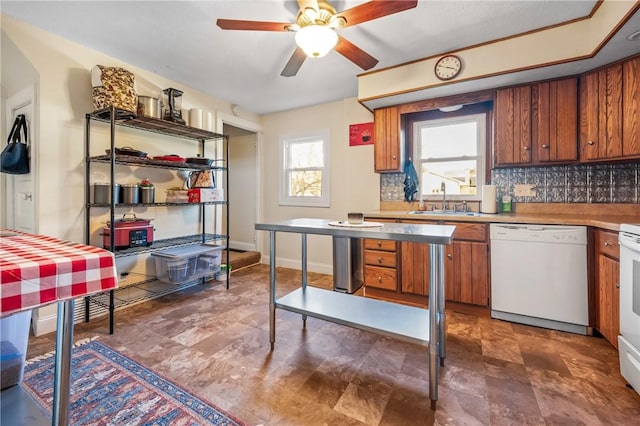 kitchen with sink, white appliances, plenty of natural light, and backsplash