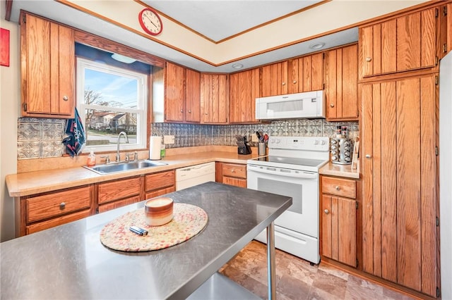 kitchen featuring white appliances, sink, and tasteful backsplash