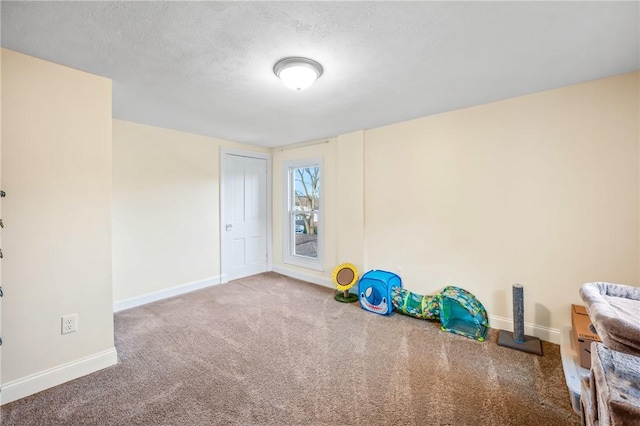 game room featuring carpet flooring and a textured ceiling