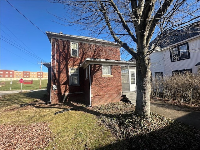 back of property featuring a lawn