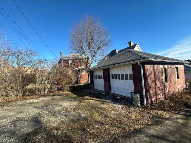 view of home's exterior with a garage and an outdoor structure